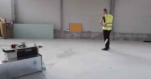 A construction worker, talking on the phone and walking irritated Stock Footage 127033213