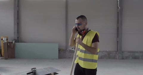 A construction worker, talking on the phone and walking angry and stirred. Stock Footage 127204802