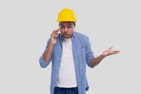Construction Worker Talking on the Phone Angry. Architect Holding Phone. Yellow Stock Photos