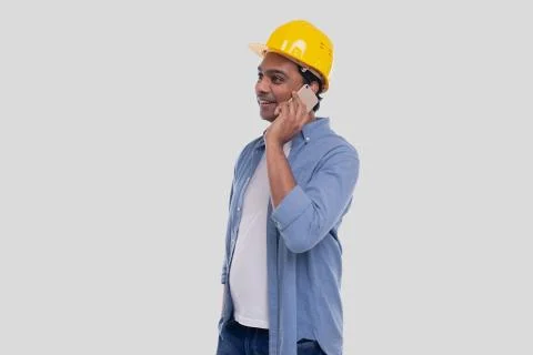 Construction Worker Talking on the Phone. Architect Holding Phone. Yellow Hard Stock Photos