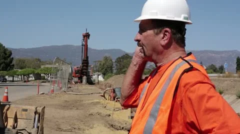 Construction worker talks on walkie talkie Stock Footage 11809476