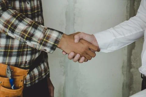 Construction worker team contractor hand shake with engineer Stock Photos