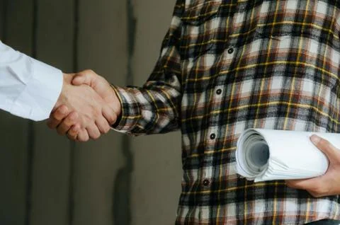 Construction worker team contractor shaking hands with engineer Stock Photos