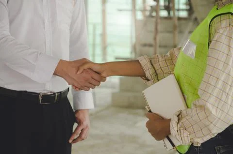 Construction worker team hands shaking after consultation meeting to greeting Stock Photos