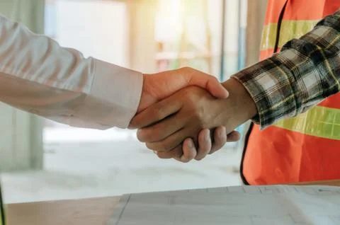 Construction worker team hands shaking after consultation meeting to greeting Stock Photos