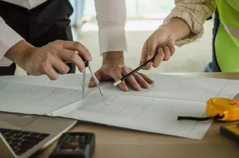 Construction worker team planning about building plan with blueprint Stock Photos