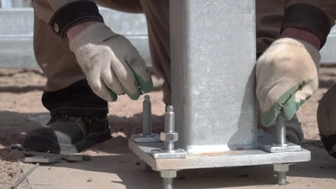 A construction worker tightens a bolt with a metal wrench. close-up back view. Stock Footage 166452977