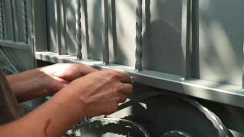 Construction worker tightens a Bolt with a metal Wrench Stock Footage 258645548