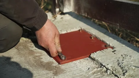 Construction worker tightens a Bolt with a metal Wrench Stock Footage 268794523