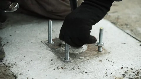 Construction worker tightens a Bolt with a metal Wrench Stock Footage 268794529