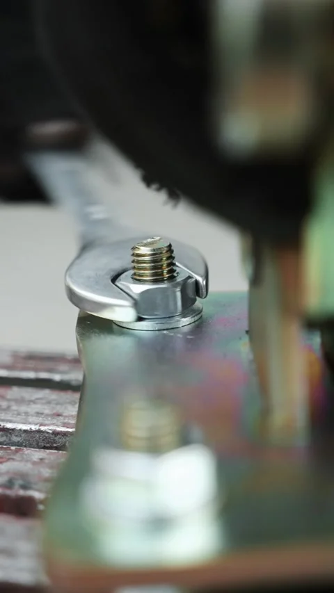 Construction worker tightens a Bolt with a metal Wrench Stock-Footage 274530298