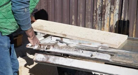 Construction worker with tile for house building. Stock Photos