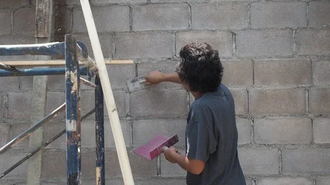 Construction worker with trowel plastering a wall. Stock Footage 125523044