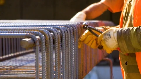 Construction worker tying bars with wire Stock Footage