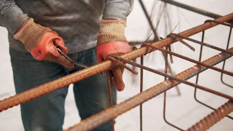 Construction worker tying rebar framework for concrete reinforcement Video stock 292661371
