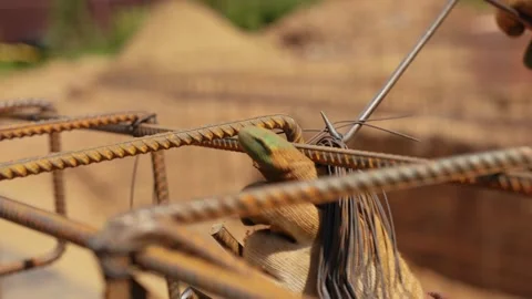 Construction worker tying steel rebar for concrete foundation Stock Footage 341294663