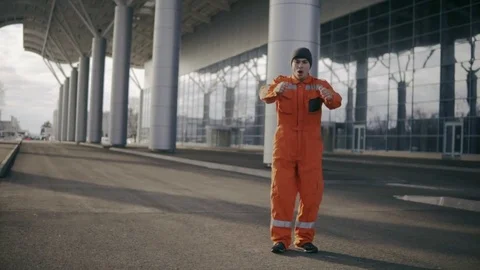 Construction worker in uniform doing difficult somersault and falling down Stock Footage 73006289