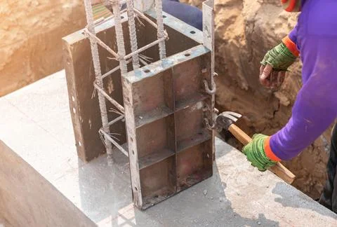 Construction worker use hammer hit clamp pin formwork tigh. Stock Photos
