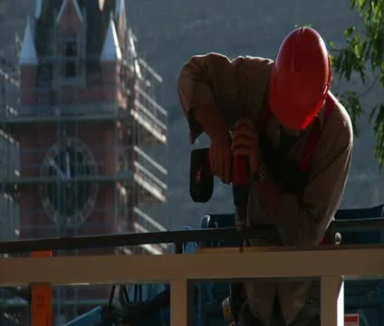 Construction worker uses drill Stock Footage 21561139
