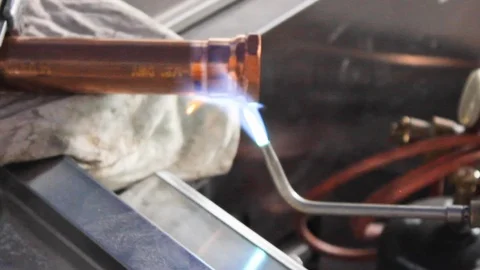 Construction worker uses electrical heat tempering on bronze metal B 스톡 동영상 125057029