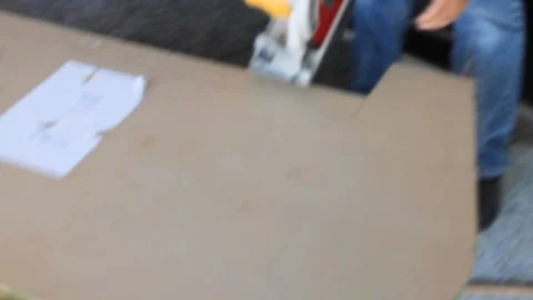 Construction worker uses hand held circular electrical saw on wood work A Stock Footage 125057082