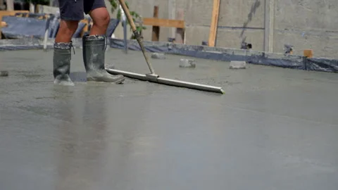 Construction worker uses special tool to level concrete. Paving of the concrete Stock Footage 281094037