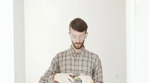 Construction worker uses tape measure Stock Footage 92316679
