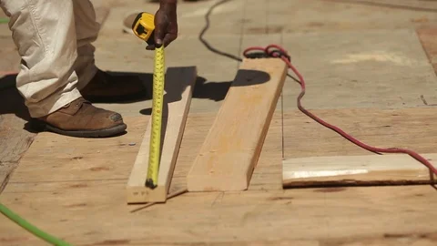 A Construction Worker Uses A Tape Measure To Mark A Beam Stock Footage 106594110