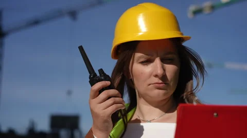 A construction worker uses a walkie talkie to communicate with the team  Stock Footage 311857981