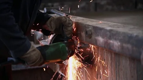 Construction worker using an angle grinder producing a lot of sparks. Stock Footage 70208074