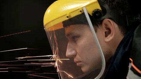 A construction worker using an angle grinder throwing sparks. Work safety Stock Footage 98997551
