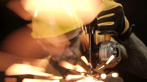 A construction worker using an angle grinder throwing sparks. Work safety Stock Footage 99130195