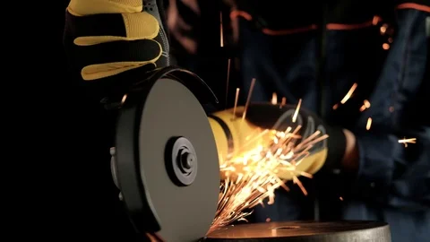 A construction worker using an angle grinder throwing sparks. Work safety Stock Footage 99130199