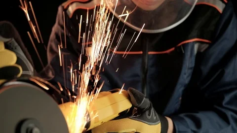 A construction worker using an angle grinder throwing sparks. Work safety Stock Footage 99130204