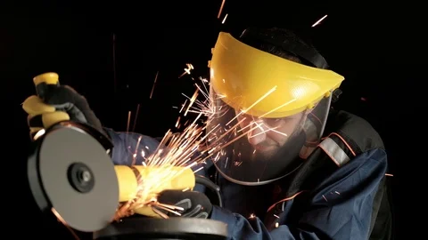 A construction worker using an angle grinder throwing sparks. Work safety Stock Footage 99130212