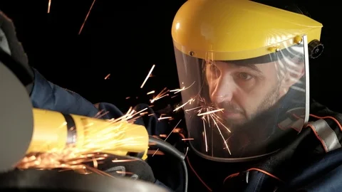 A construction worker using an angle grinder throwing sparks. Work safety Stock Footage 99130223