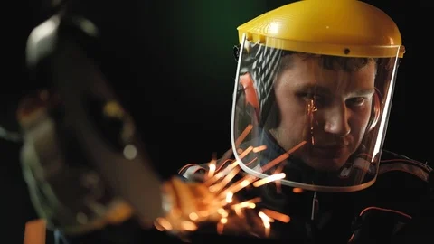 A construction worker using an angle grinder throwing sparks. Work safety Stock Footage 99269959