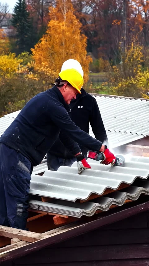 Construction worker using an angle grinder to cut corrugated roofing sheets Stock Footage 339754348
