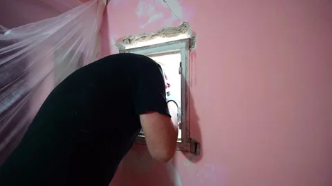 Construction worker using angle grinder to remove a window frame Video stock 347640533