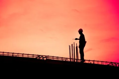 Construction worker using CB radio on a construction site,for construction te 写真素材