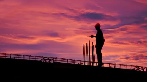 Construction worker using CB radio on a construction site,for construction te 写真素材
