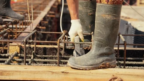 Construction worker using concrete vibrator on building site Stock Footage 341294427