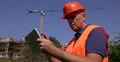 Construction Worker Using Digital Tablet Master Builder Man Planning Modern Tech 4k or 4k+ Resolution