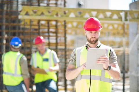 Construction worker using digital tablet in construction site Stock Photos