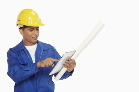 Construction worker using a digital tablet Stock Photos