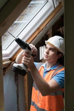 Construction Worker Using Drill To Install Replacement Window 写真素材