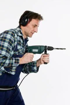 A construction worker using a drill Stock Photos