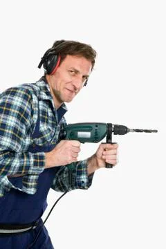 A construction worker using a drill Stock Photos