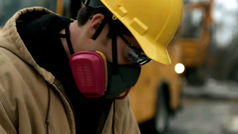 Construction worker using equipment and wearing respirator 4k Stock Footage 88961068