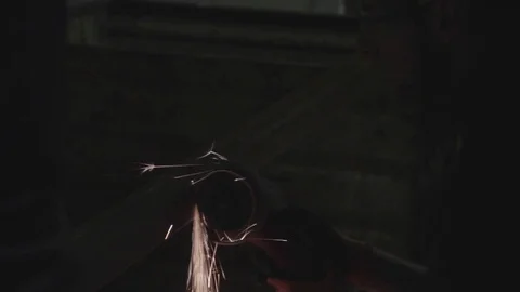 Construction worker using grinder in the dark Stock Footage 69767364
